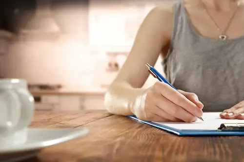 Female homeowner working at their kitchen table