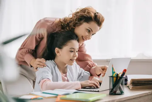 Mother working with their young daughter on her homework